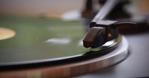 The vinyl record is spinning. The needle plays on a vintage vinyl record. Old Stock Footage 147153690