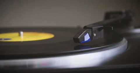 The vinyl record is spinning. The needle plays on a vintage vinyl record. Old Video stock 147155253