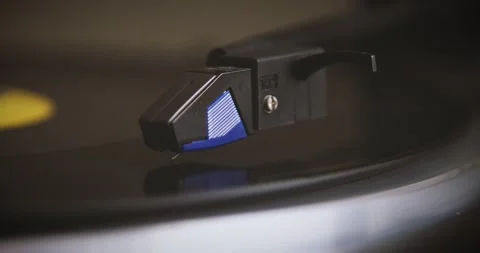 The vinyl record is spinning. The needle plays on a vintage vinyl record. Old Stock Footage 147155254