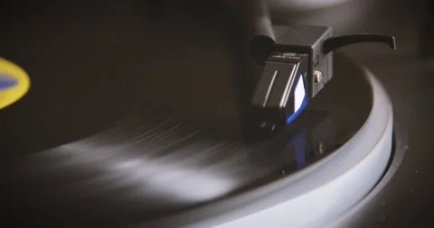 The vinyl record is spinning. The needle plays on a vintage vinyl record. Old Stock Footage 147155276