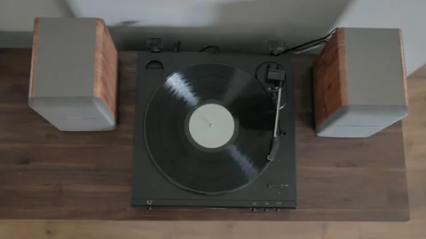 Vinyl record spins on automatic record player 動画素材 169063618