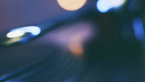 Vinyl record turntable. Slide rotating plate, needle, blurry bright bokeh lights Stock Footage 91682905