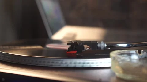 Vinyl Record With USA Flag Sticker Playing on Turntable and Cigarette Smoke in Stock Footage 337624795