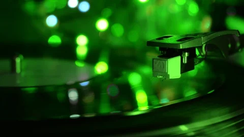 Vinyl turntable record player needle drop. Acid green light background. Stock Footage 96383388