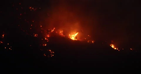 Violent dark night mountain forest fire explosions 4K Stock Footage 138842121