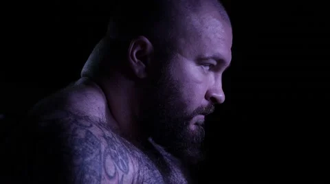 Violent face of a bald amd bearded muscular mobster. 4K UHD Stock Footage 68355984