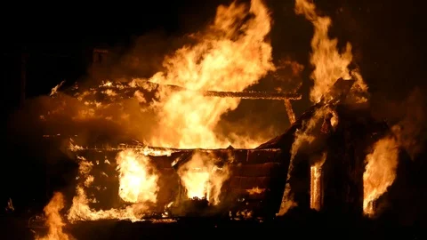 Violent fire destroying the higher portion of a historical house in North Stock Footage 115013119