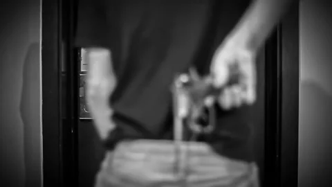 Violent guy holding a gun and kicks open a door Stock Footage 132140490