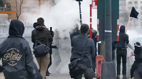Violent protesters fighting with fumigene, explosion and launching bricks Stock Footage 89522658