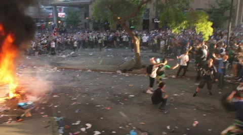 Violent riots: car on fire with pan to crowd Video stock 38925852