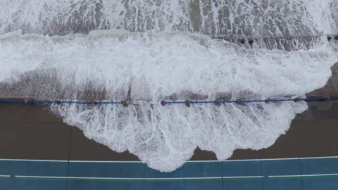 Violent sea waves crash against waterfront road as typhoon approaches coastal Stock Footage 340856821