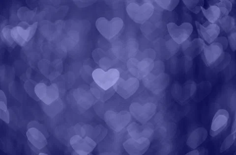 Violet abstract bokeh background in the shape of hearts. Valentines day textu Stock Photos