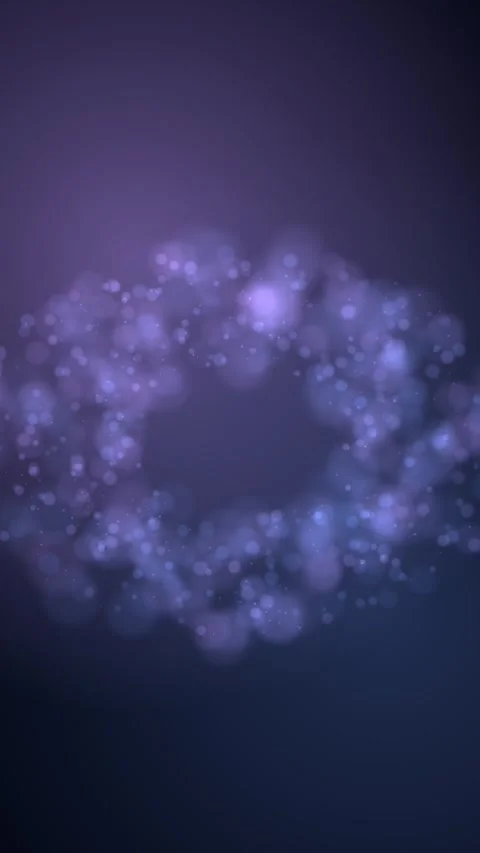 Violet and blue bokeh lights rotate clockwise around a dark center Stock Footage 345185725