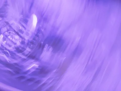 Violet bokeh abstract light background. Motion blur violet backdrop. Fotos Stock