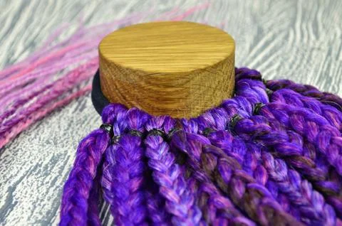 Violet braids on a gray background at close range Stock Photos