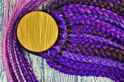Violet braids on a gray background at close range Stock Photos