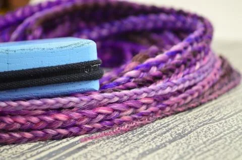 Violet braids on a gray background at close range Stock Photos