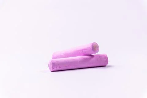 Violet chalks on a white background. Education. Stock Photos