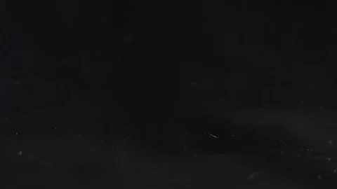 Violet chaminic sparkles falling on the black background, abstract slow motion Stock Footage 75971320