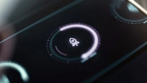 Violet circular control surrounds small rocket icon Stock Photos