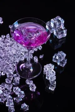 Violet coctail with ice cubes Stock Photos