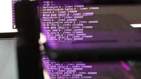 Violet computer software code moving on a black monitor reflect on glass. Abs 스톡 동영상 143870712