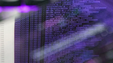 Violet computer software code moving on a black monitor reflect on glass. Abs 스톡 동영상 144047066