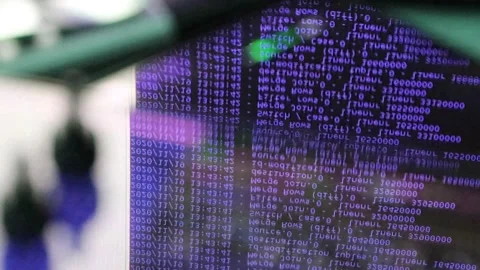 Violet computer software code moving on a black monitor reflect on glass. Abs Stock Footage 144047514