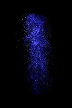 Violet dust explosion isolated on black background Stock Photos