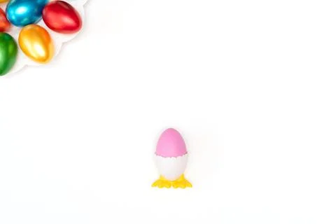 Violet easter egg in chicken stand on white background with painted easter eggs Stock Photos