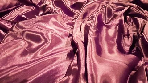 Violet fabric close up background. Smooth elegant silk or satin texture can.. Stock Photos