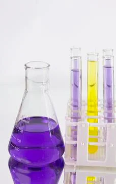 Violet fluid flask Stock Photos