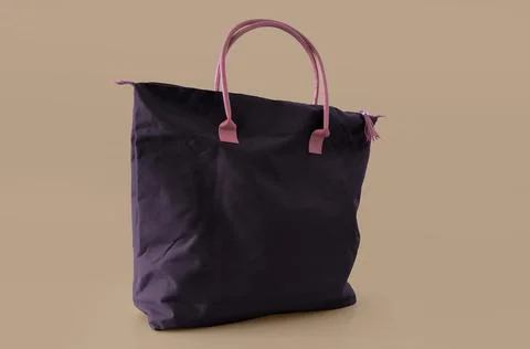 Violet handbag on a beige background Stock Photos
