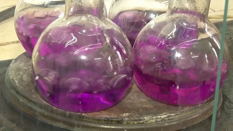 Violet liquid is boiled in glass flasks. Stock Footage 127320984