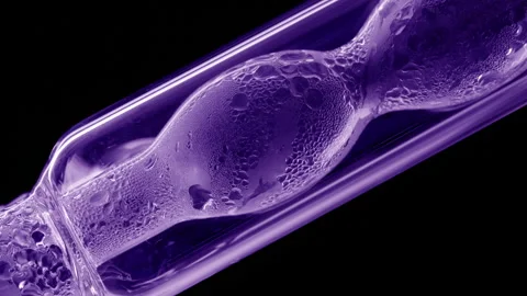 Violet liquid condensing on bulb lab condenser black background Stock Footage 335222816