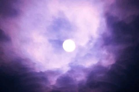 The violet moon in clouds Stock Photos