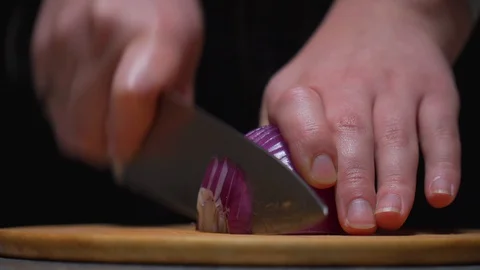 Violet onion chopping with big knife Stock Footage 128517088