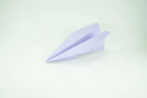 Violet paper plane on a white background, isolated. Concept (idea) of airline Stock Photos