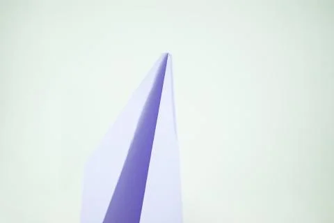 Violet paper plane on a white background, isolated. Concept (idea) of airline Foto stock