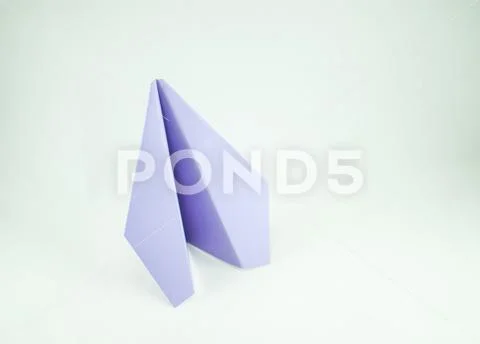 Violet paper plane on a white background, isolated. Concept (idea) of airline Stock Photos