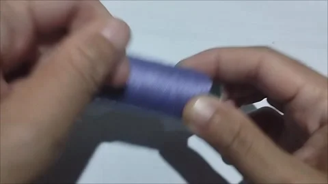 Violet Sewing Thread Spool Lying on White Background Stock Footage 296978616