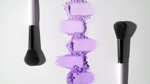 Violet smeared powder heaps on light grey background Stock Footage 340503372