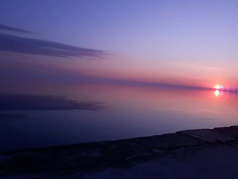 Violet sunset on the beach Stock Photos