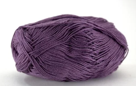 Violet tangle of natural wool for needlework on white background Stock Photos