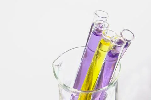 Violet test tubes in beaker Fotos de archivo