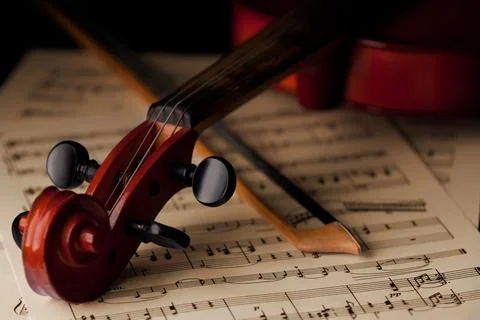 Violin and bow on classical sheet music Stock Photos