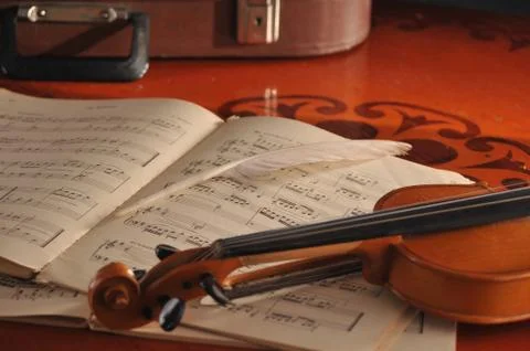 Violin and notes on the table Stock Photos