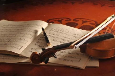 Violin and notes on the table 스톡 사진