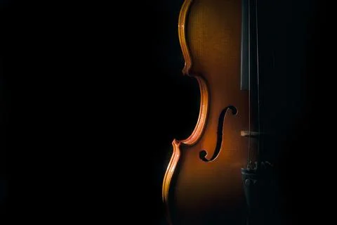 Violin on a black background with spot light Stock Photos