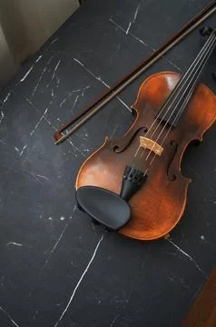 Violin bow next to it on the couch Stock Photos